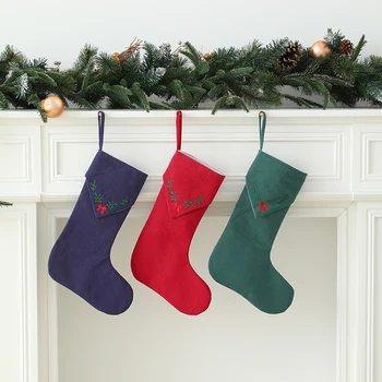 Weihnachtsstrumpf mit gestickten grünen Blättern und roter Schleife, bunter Baumwoll-Leinen-Strumpf